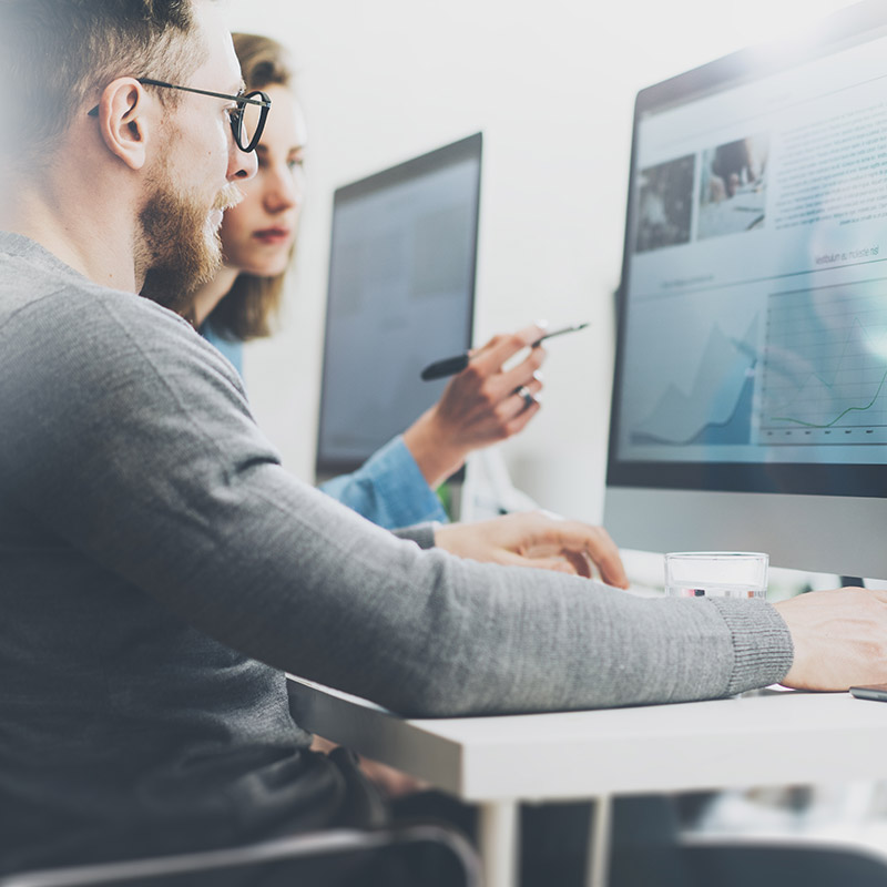 Website designers pointing at computer screen